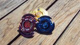 Jawas Junkyard Egyptian God Bey Trio Pack: Ra, Obelisk, and Slifer. Red, blue, and gold metal Beys with dragon designs and blue gem accents.